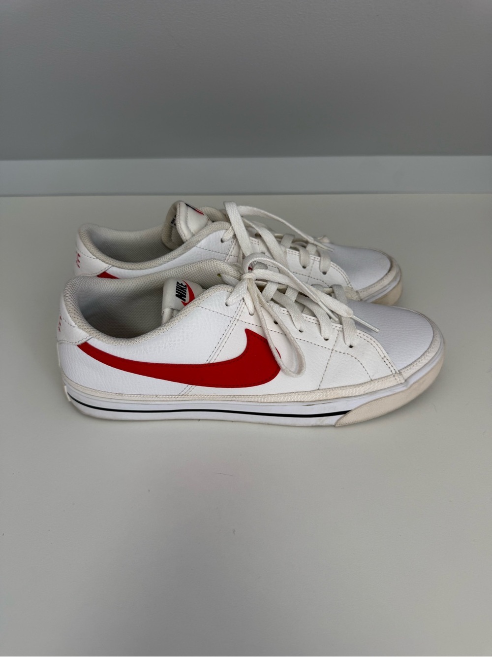 Nike White Sneakers with Red Swoosh Accent